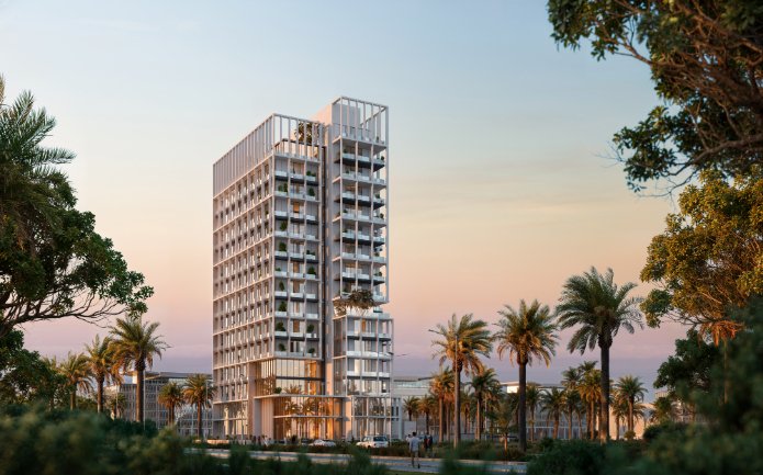Modern high-rise building at Muheira Maysan surrounded by palm trees at sunset.