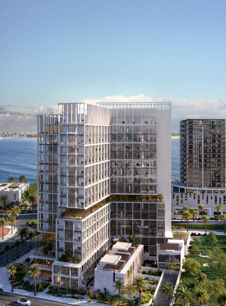Modern high-rise building at Muheira Maysan with a stunning waterfront view and lush greenery.