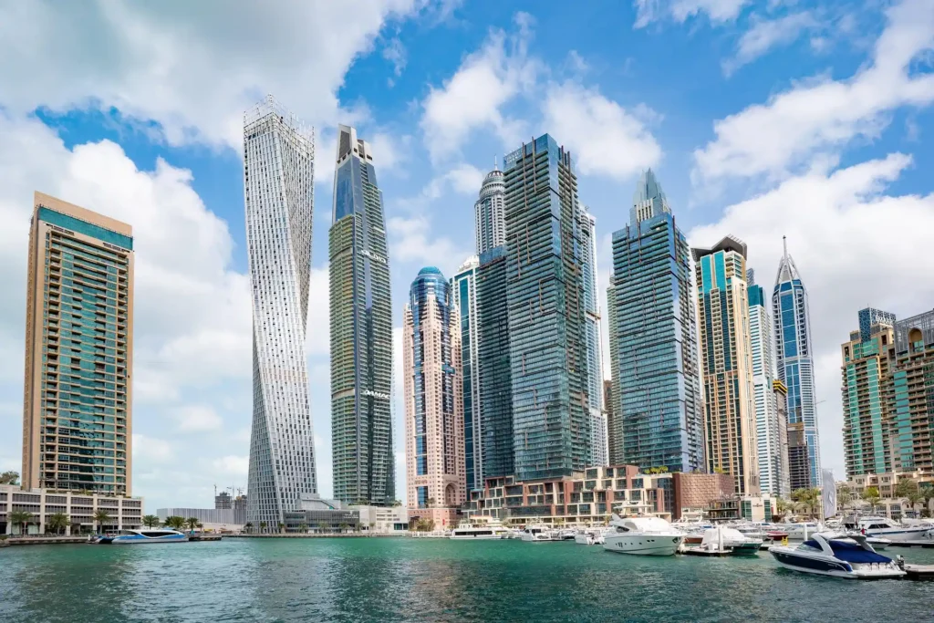 Studio Apartments for Sale in Dubai showing Modern skyline with waterfront and boats