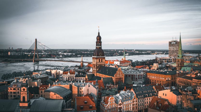 buy property in latvia with cityscape and river and historic buildings