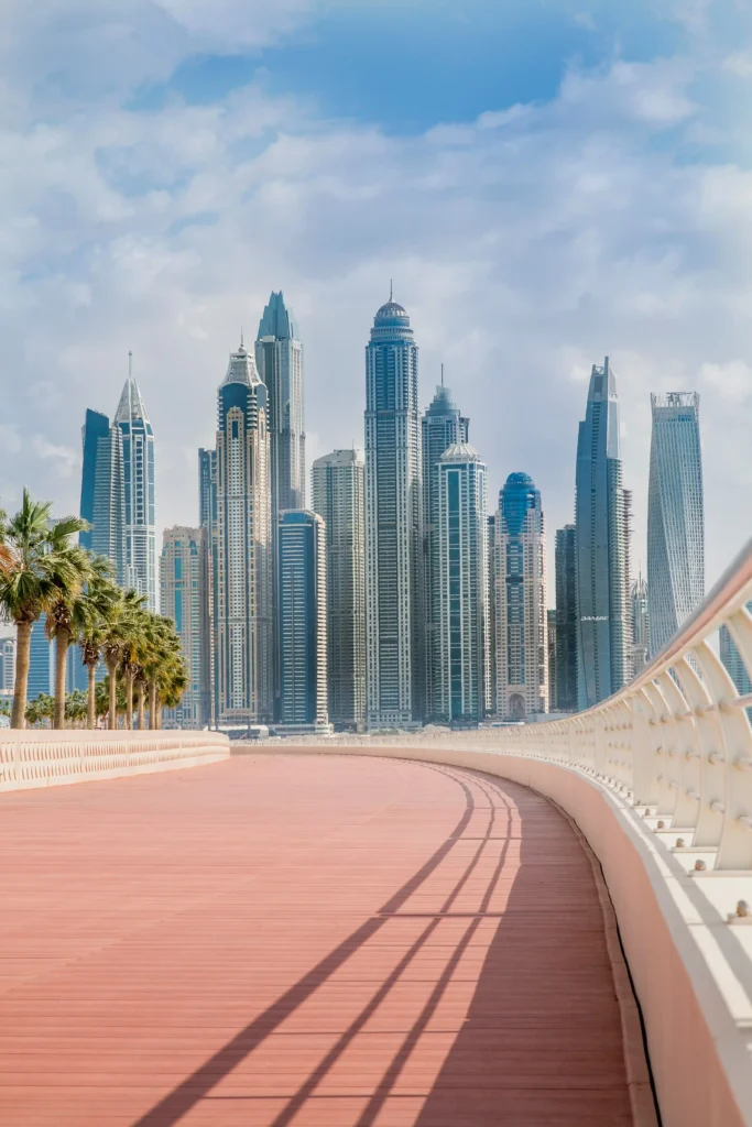 apartments for sale in UAE with Modern skyscrapers beside a curved walkway.