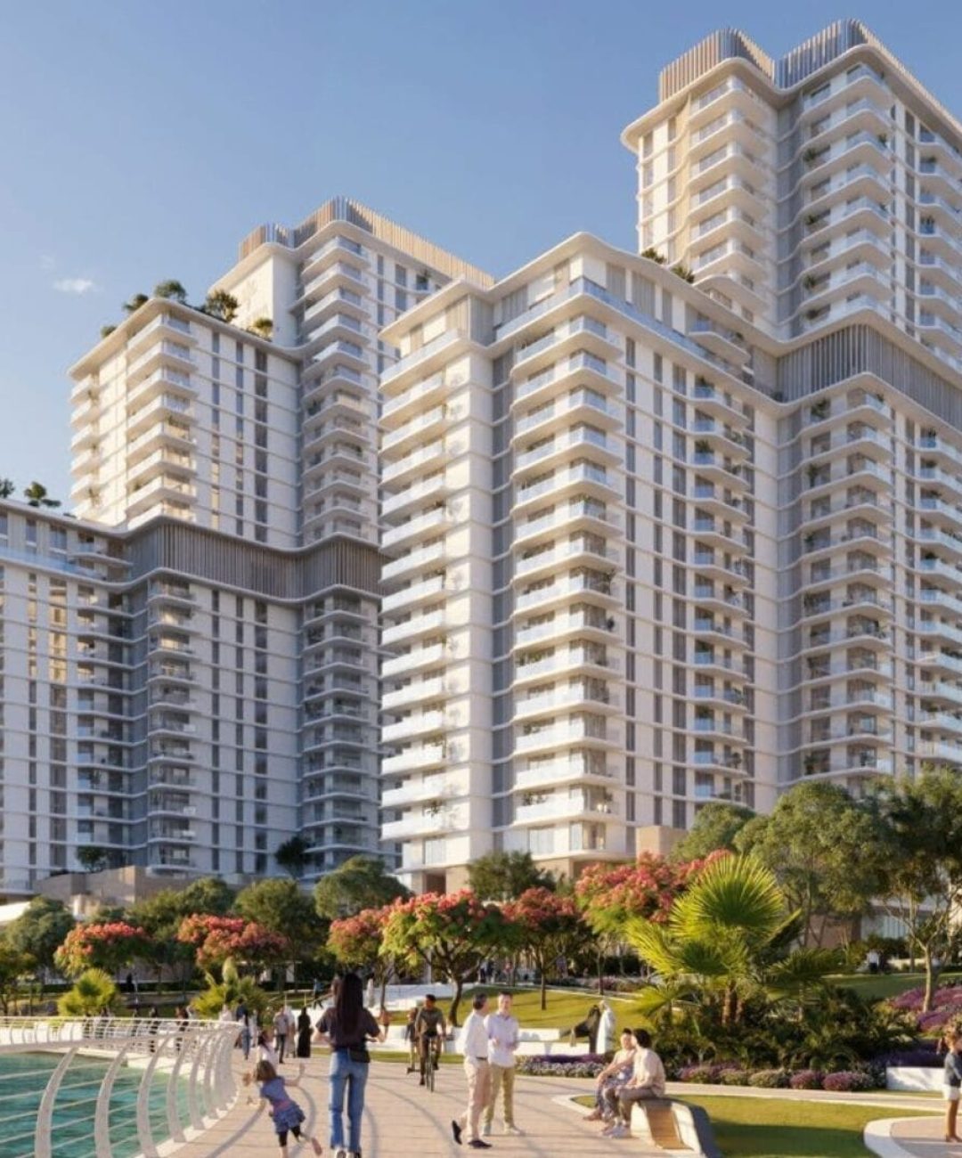 Modern high-rise buildings at Muheira Maysan with a landscaped promenade and residents enjoying the outdoors.